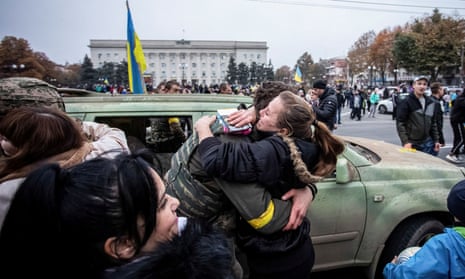 A woman hugs a Ukrainian soldier after Russia’s retreat from Kherson.