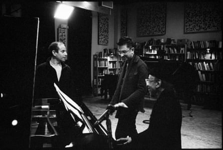 Three men around a piano