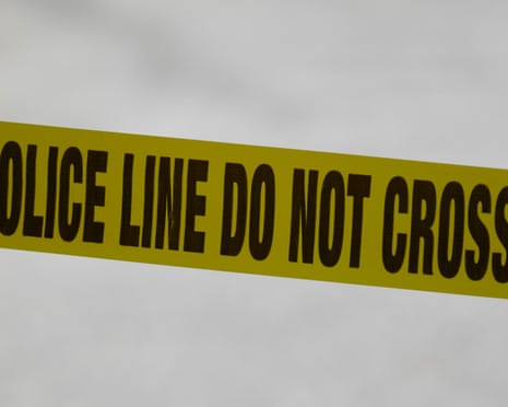 Yellow tape with words 'police line do not cross on it' in black font