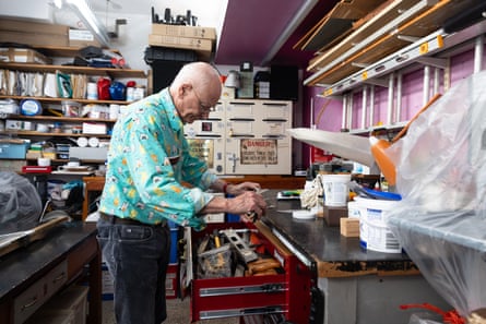 Kruszelnicki looks through a drawer in a large cluttered room