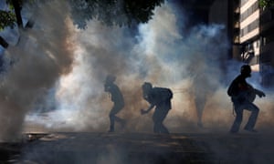 Opposition supporters clash with riot security forces in Caracas on Saturday.