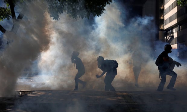 Opposition supporters clash with riot security forces in Caracas on Saturday.