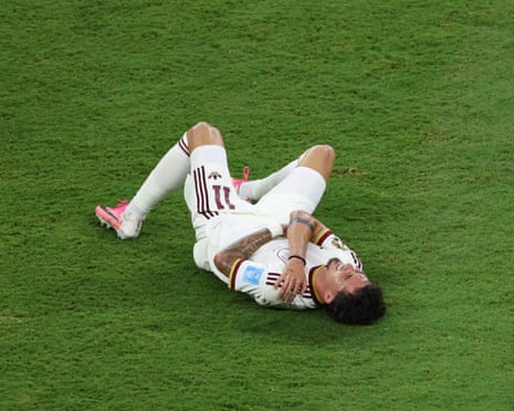 Yéremy Pino lies on the pitch after sustaining an injury against Uruguay