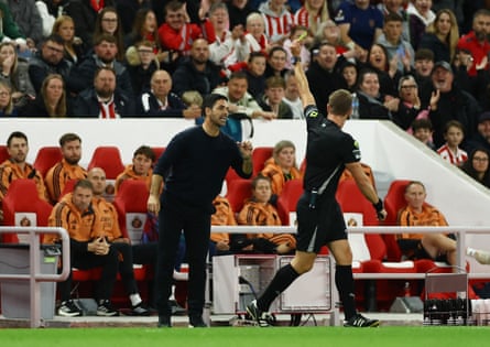 Mikel Arteta is booked by John Brooks for leaving his technical area