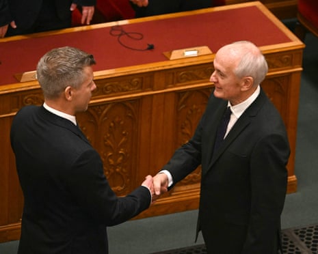 Hungary’s newly elected president András Baka shakes hands with Hungarian prime minister Péter Magyar after he was elected at the parliament in Budapest.