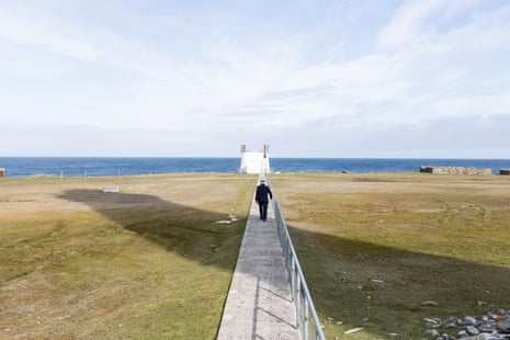 Billy Muir walking in the shadow of the North Ronaldsay lighthouse