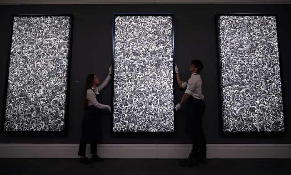 Art handlers next to a piece titled Mandy at Sotheby's in London