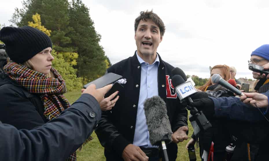 Justin Trudeau speaks with the media while campaigning in Mont Joli, Quebec, on Friday.