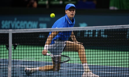 Jannik Sinner plays a shot at the net.
