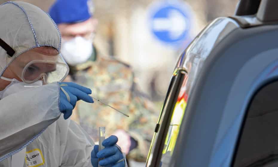 A member of the German armed forces helps out at a mobile coronavirus testing station.