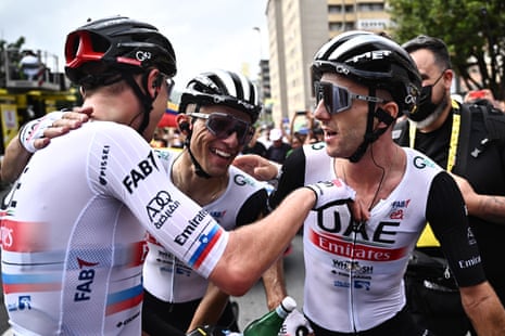 British rider Adam Yates (R) of team UAE Team Emirates celebrates with teammates after winning the first stage of the Tour de France in Bilbao.