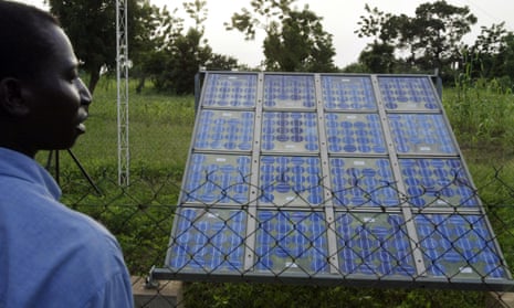 A resident of Tanghin-Dassouri, near Ouagadougou in central Burkina Faso, looks at a solar panel