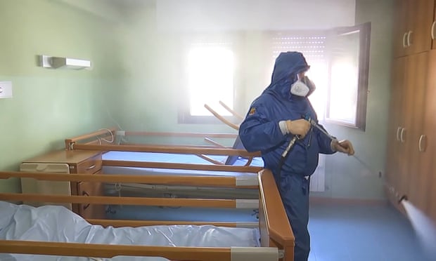 A member of a Russian radiological, chemical and biological defence unit disinfects a retirement home in Lombardy, Italy.