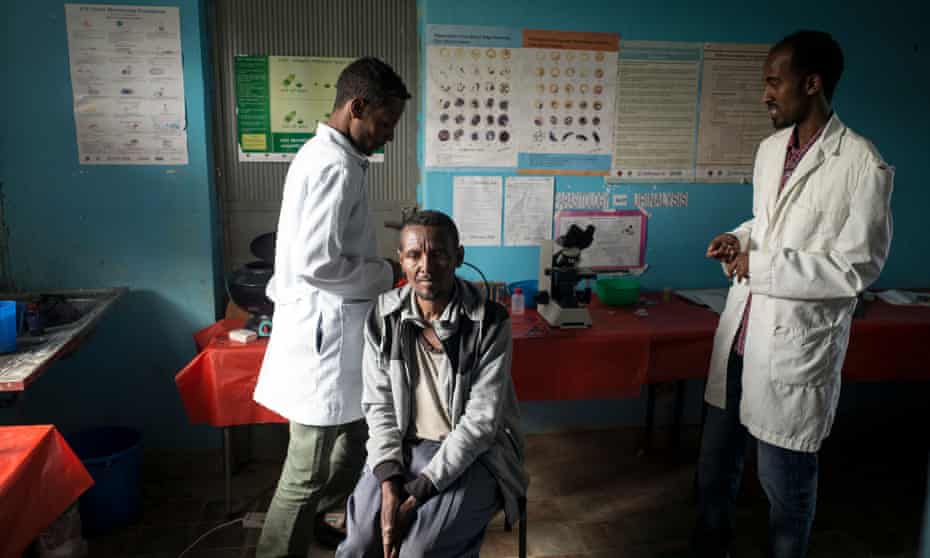 A man waits to be tested for malaria in Debarq, Ethiopia. A relatively cheap scanner offers hope in detecting fake malaria drugs.
