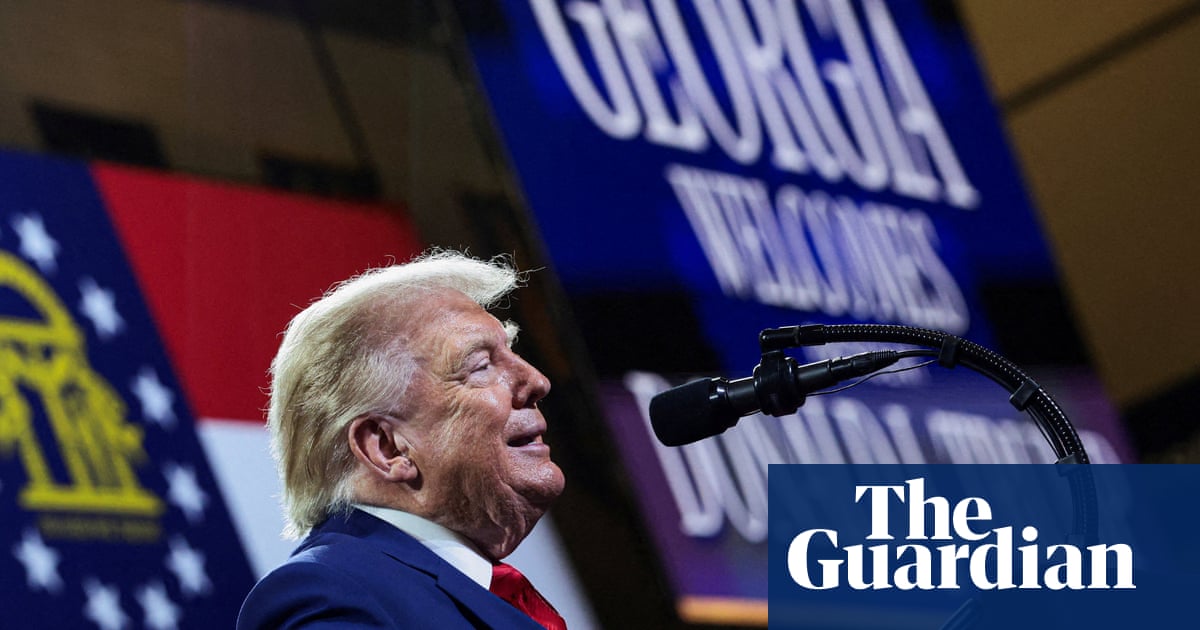 Trump in a Georgia high school gym explaining that national debt is bad, except when it’s his, and that the solution to unaffordable living costs is a branded investment account for babies.