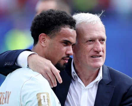 France coach Didier Deschamps and Warren Zaire Emery celebrate after the match against Morocco.