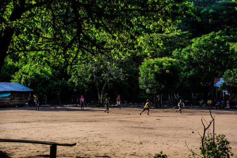 Yukpa children playing football with forest in the background