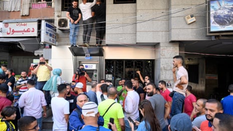 Customers storm banks to get their money in Lebanon – video