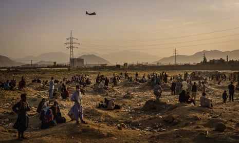  A military transport plane launches off while Afghans who cannot get into the airport to evacuate, watchKabul, Kabul Province, Afghanistan - 23 Aug 2021