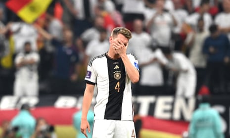 Matthias Ginter covers his face after Germany go out of the World Cup despite victory against Costa Rica