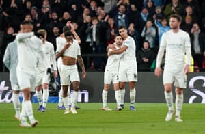 The Manchester City players and fans react after the final whistle.