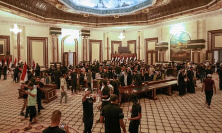 The cleric’s supporters gather in a large room in the palace