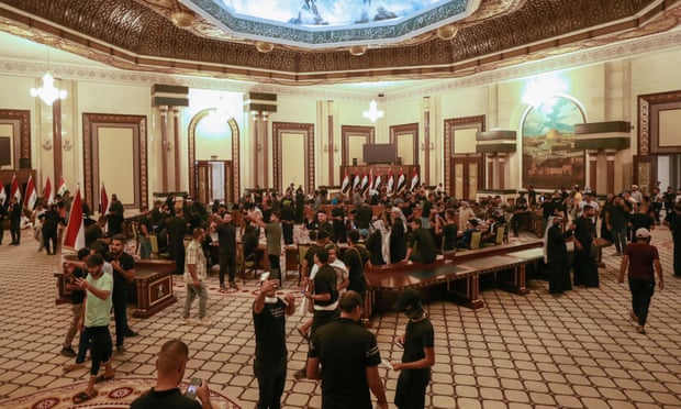 The cleric’s supporters gather in a large room in the palace