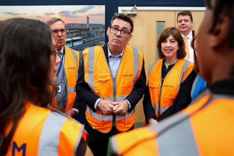 Andy Burnham and Lucy Powell in hi vis speaking to apprentices at the Alstom factory in Derby.