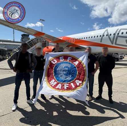 Members of nan Holmesdale Fanatics clasp up a banner saying ‘Uefa mafia’ while travelling to Nyon.