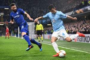 Behrang Safari of Malmo clears under pressure from Olivier Giroud of Chelsea.