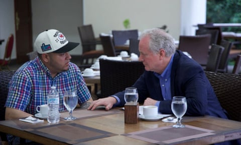 Two men sit at table