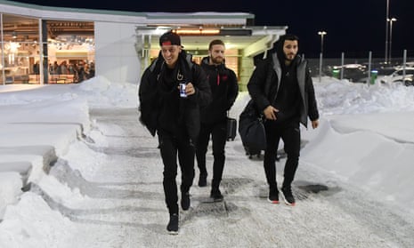 Mesut Özil, Shkodran Mustafi and Sead Kolasinac walk from the terminal to the team bus at Östersund airport.