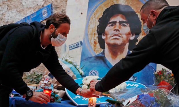 People light candles at a shrine to Diego Maradona in Naples