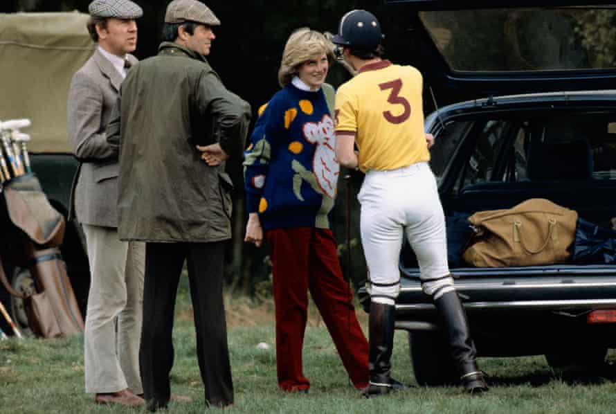 Pregnant Diana, Princess of Wales, chatting with Prince Charles, Prince of Wales at a polo match, Windsor, May 1, 1982. Diana is wearing a jumper with a koala motif by Australian designer Jenny Kee.