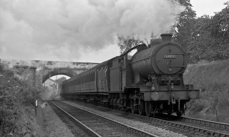 A steam train passes under the bridge in 1957. 
