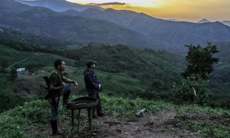 FARC guerillas on guard during the days prior to their mobilization to the final concentration zones in Colombia, where they will give up their weapons