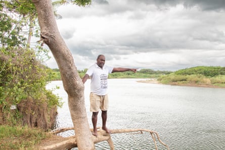 Epeli Turuva stands a few feet behind his home and points to where his plantation used to be.