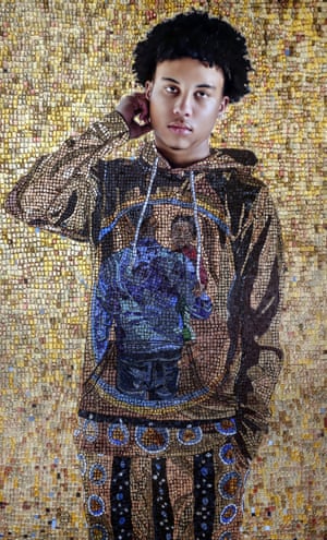 A portrait of a young Black boy in a gold mosaic sweatsuit