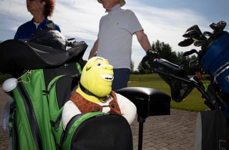 A soft Shrek cover over a golf club.