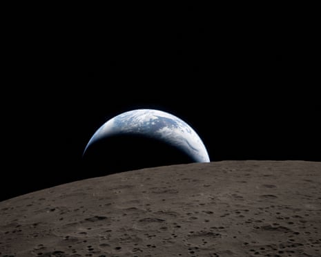 the earth, as photographed by the artemis ii crew, with the moon in front