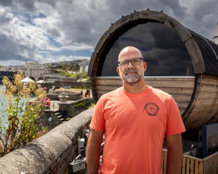 Jem Wallis stands in front of his sauna on the seafront