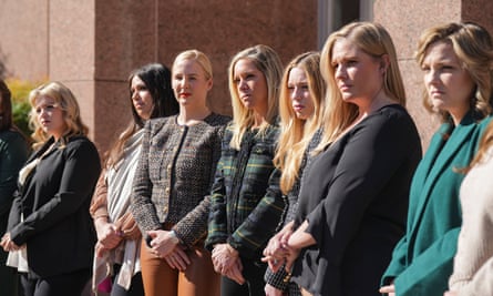 women standing in a row outside a courthouse