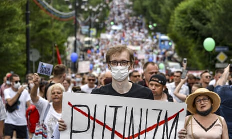A man holds poster reading 'Putinizm' during a protest in support of Sergei Furgal, the governor of the Khabarovsk region