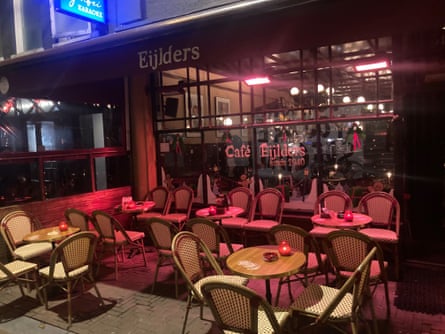 Exterior of brown bar in Amsterdam with empty seats