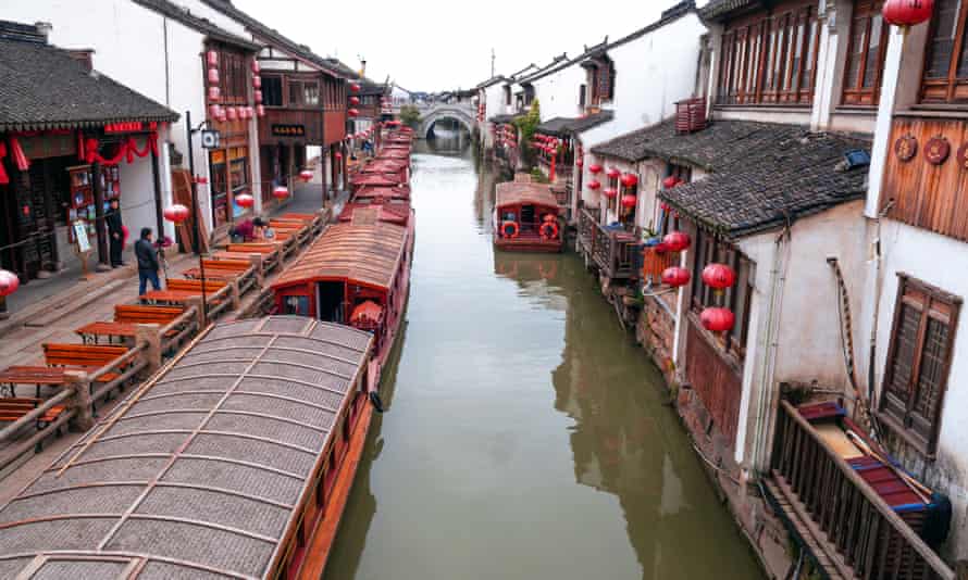 Houses with red lanterns by the canal in Suzhou.