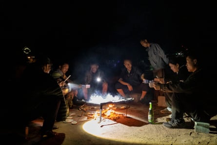 A group of people drink beer at a pine mushroom barbecue on Mt Chilbo