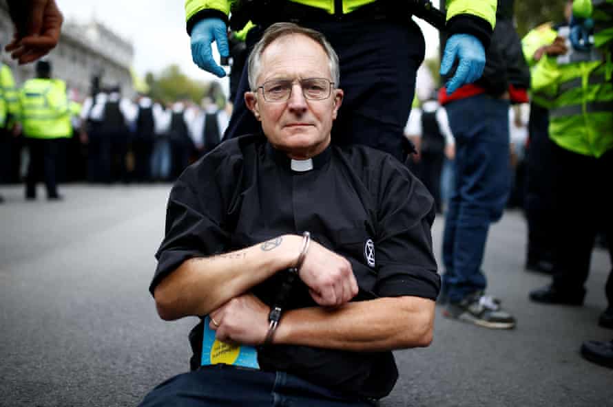 A protester is detained during an Extinction Rebellion demonstration in Whitehall, London.