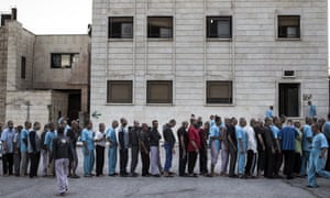 People with mental health problems are seen at the garden of a psychiatric hospital in Aleppo, Syria.