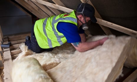 Sustainable loft insulation made from wool being installed.