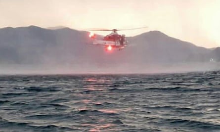 A search helicopter flying over Lake Maggiore